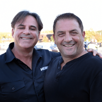 a smiling man and woman posing for the camera