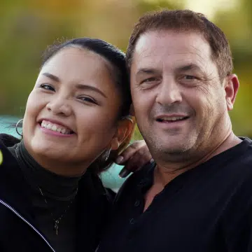 a smiling man and woman posing for the camera