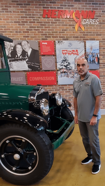 a man standing in front of a car