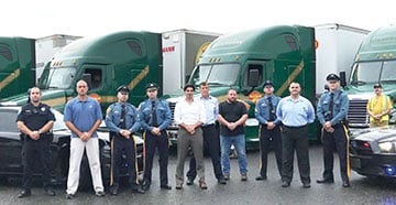 a group of people standing in front of a bus