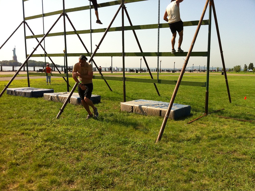 a person in a swing set in a grassy field