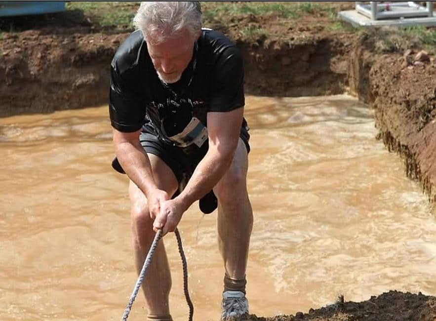 a man that is standing in the dirt