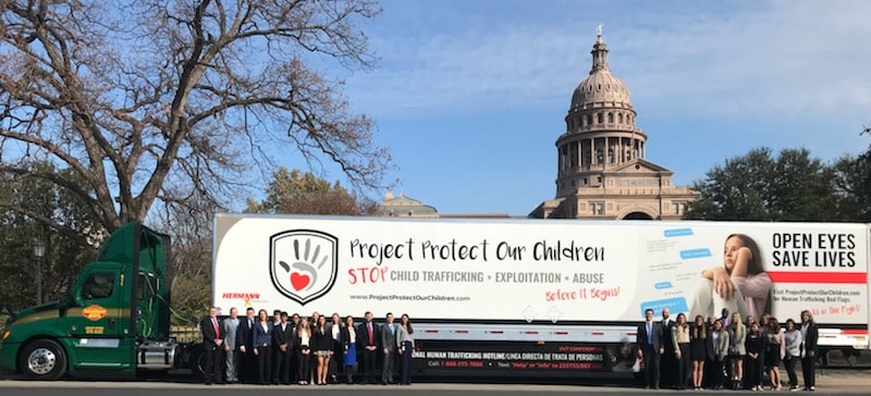 a group of people riding on the back of a truck