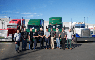 a group of people standing in front of a bus