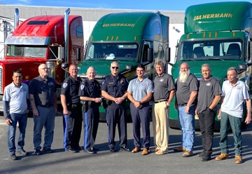 a group of people standing in front of a bus