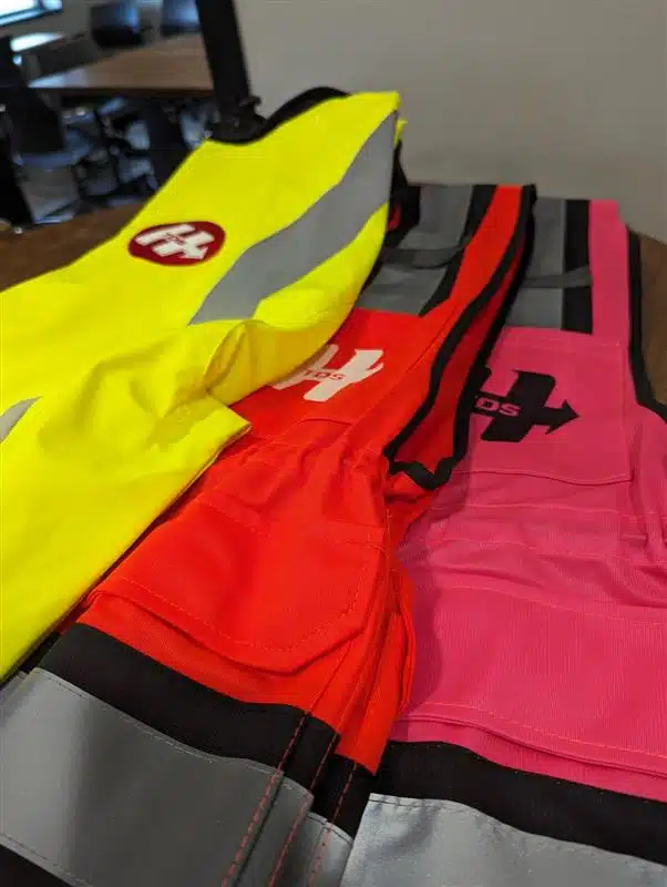 brightly colored safety vests laying on a table