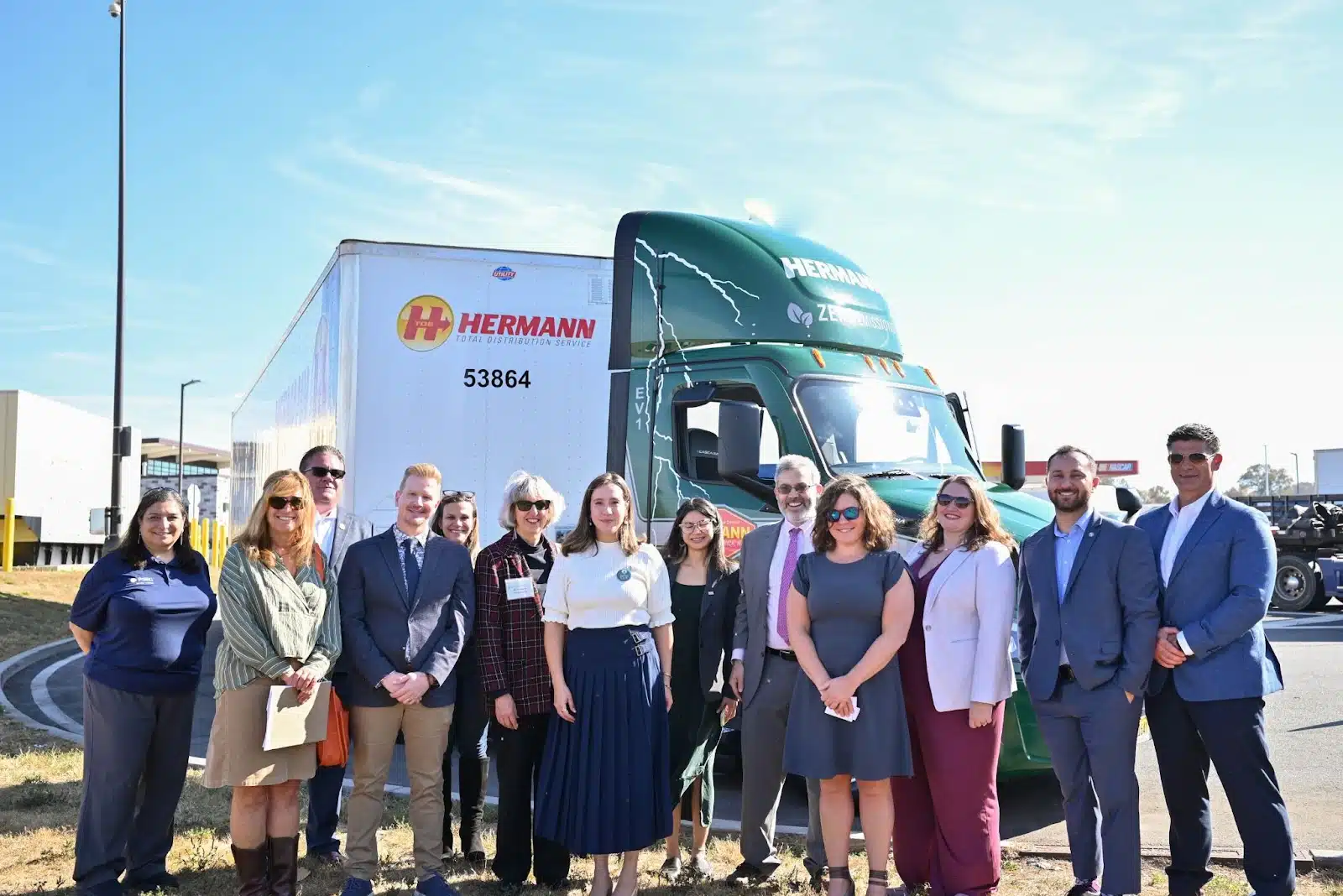 Group of people standing in front of an electric truck